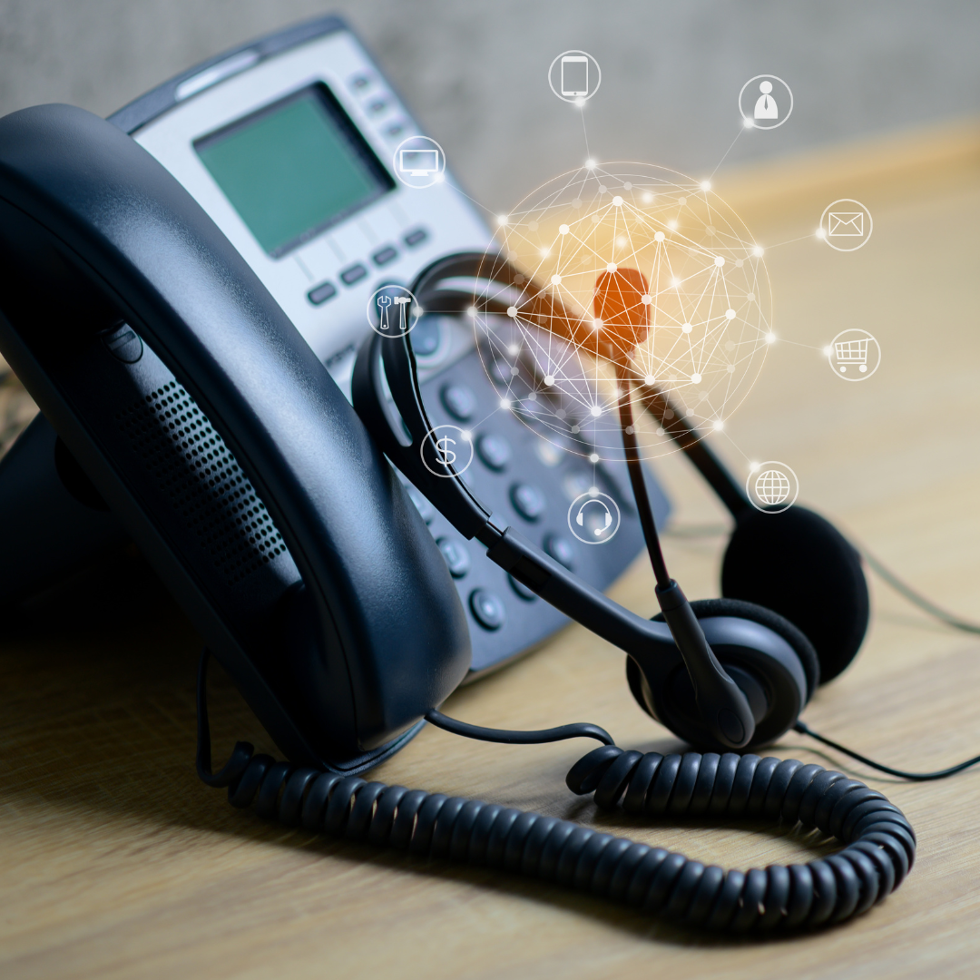 Desk phone and headset with digital communication icons, representing outdated business phone systems and the need to upgrade to modern telephony.