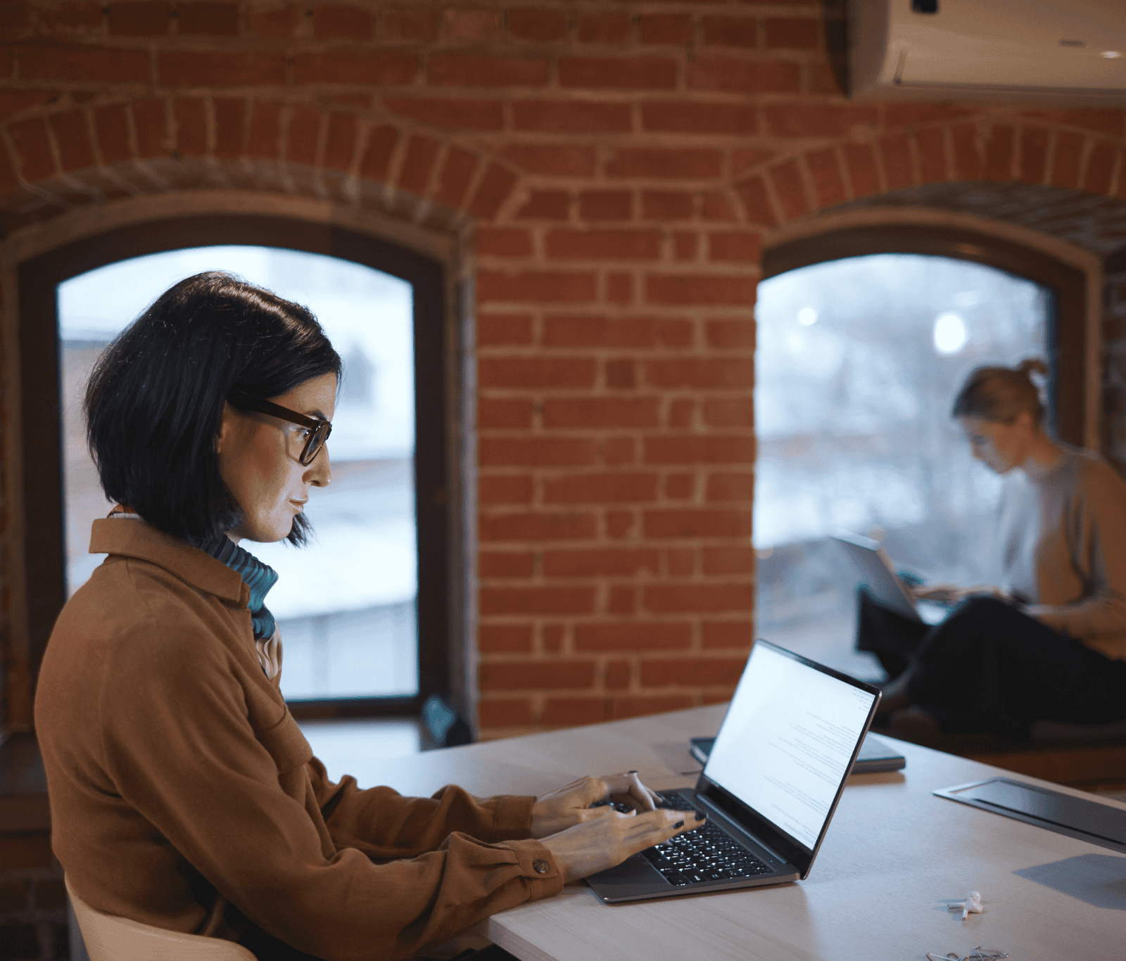 Professional working on a laptop in a modern office environment connected to a secure local area network (LAN)