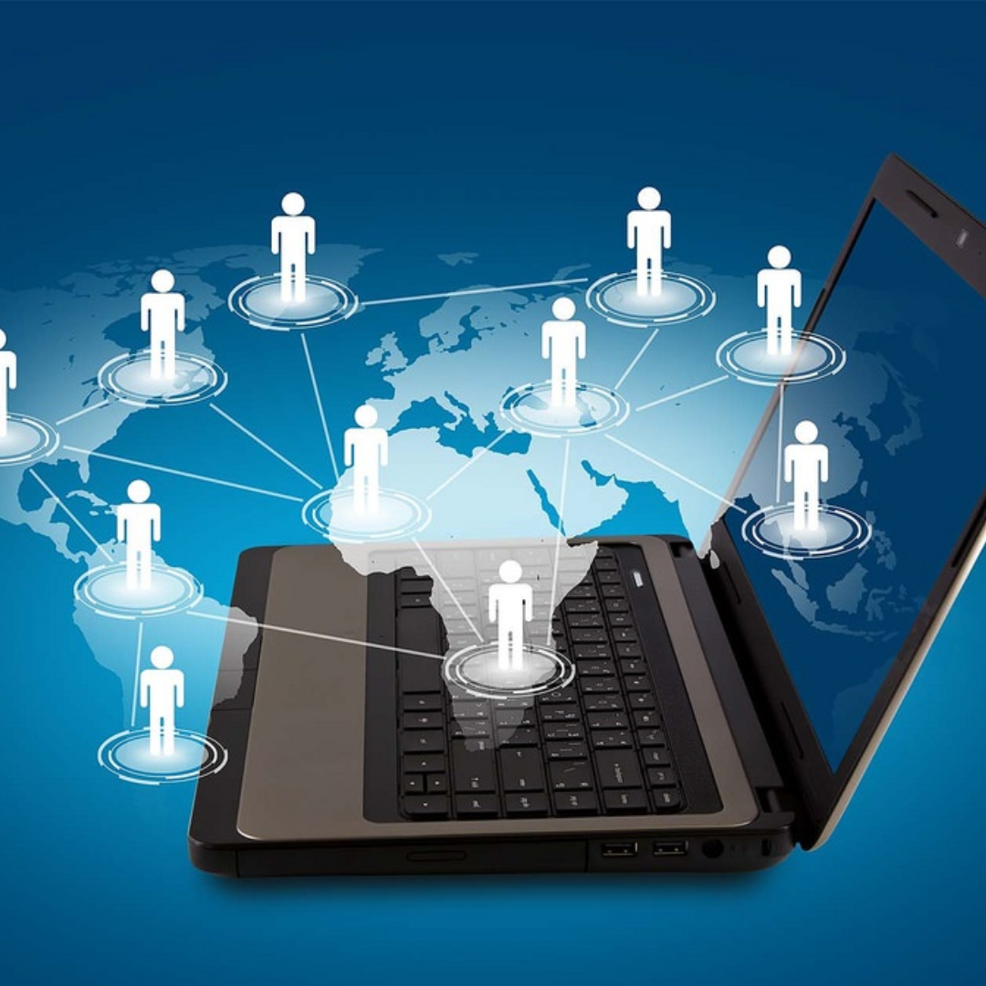 Laptop with connected user icons across a world map, representing collaborative technology and global teamwork.