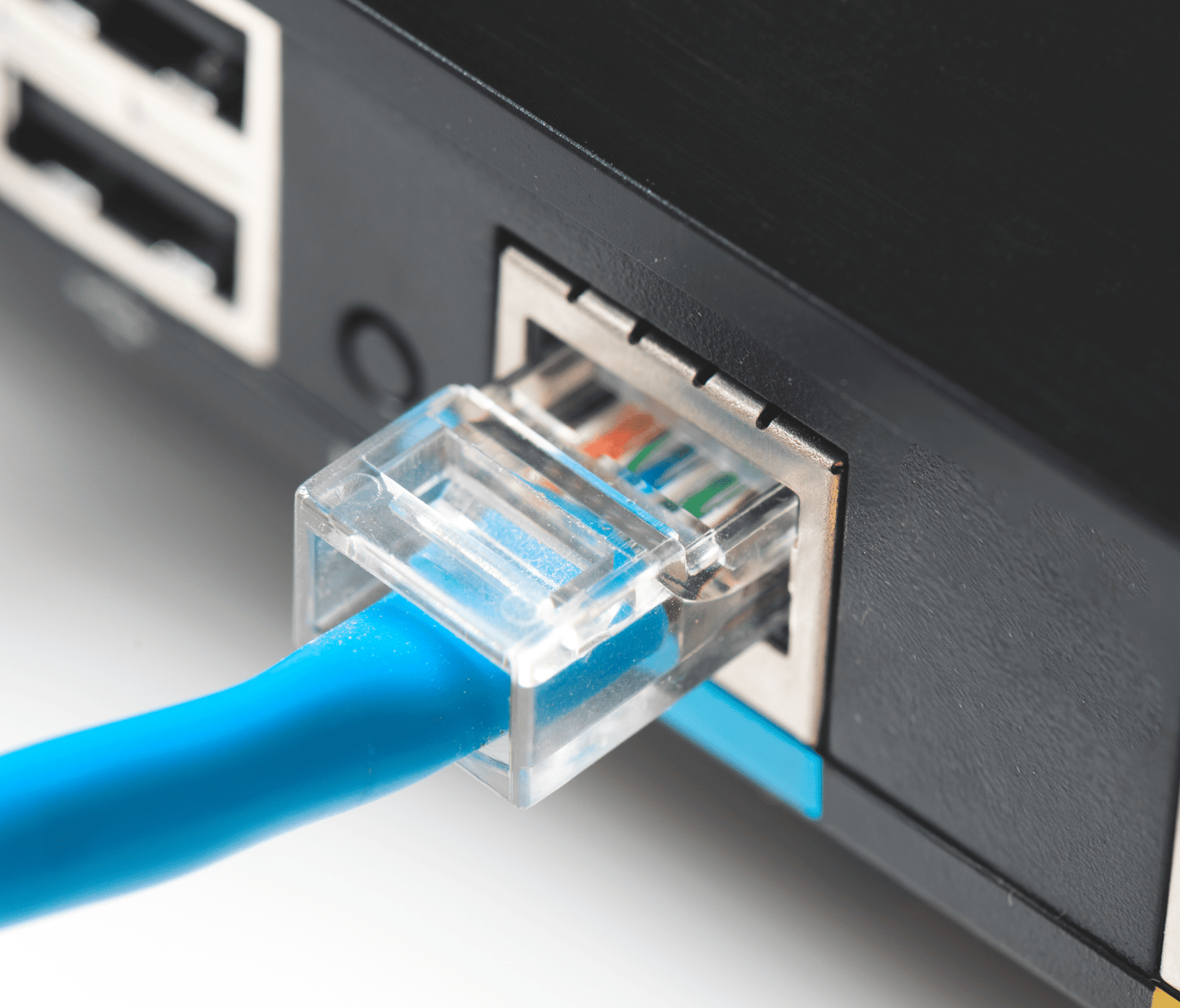 Ethernet cable connected to router port showing wired business internet connection for EoFTTC networks|Ethernet over FTTC (EoFTTC) vs FTTC comparison showing fibre cabinet connections and business internet performance